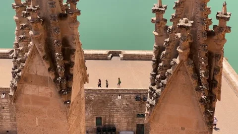 Closeup of Two Gothic Cathedral Towers with People Below Stock Footage 316836035