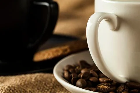 Closeup two handle mug with coffee beans Stock Photos