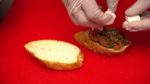 Closeup of two hands making tapas on the cutting board Stock Footage 77025539