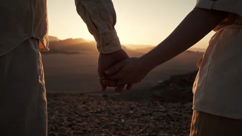 Closeup of Two hikers in Wadi Rum desert holding hands Stock Footage 271599415
