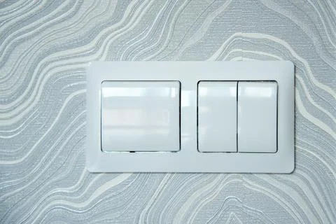 Closeup of two lighting switchs on abstract wallpaper background Stock Photos