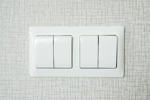 Closeup of two lighting switchs on concrete wallpaper background Stock Photos