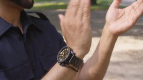 Closeup - Two men clap their hands together outside at a park - shot on RED Stock Footage 124718302