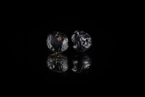 A closeup of two Metallic Asteroid 3D Rendering reflecting Over a shiny Black Stock Illustration