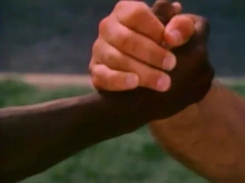 Closeup of two multi-ethnic wrestlers clasping hands, 1980s Vídeos de archivo 61445008