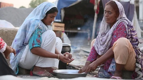 Closeup Of Two Pakistani Women Cooking Traditional Food In The Slums. Stock Footage