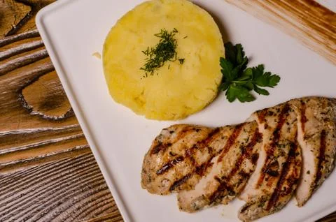 Closeup two pieces of medium raw grilled meat decorated with red pepper and s Stock Photos