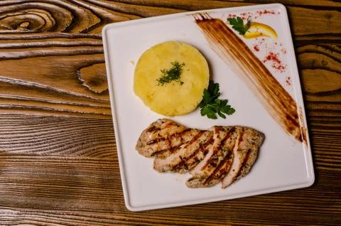 Closeup two pieces of medium raw grilled meat decorated with red pepper and s Stock Photos