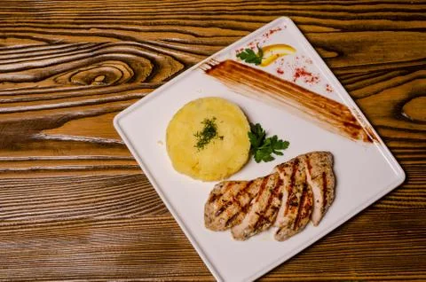 Closeup two pieces of medium raw grilled meat decorated with red pepper and s Stock Photos