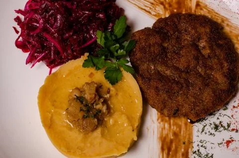 Closeup two pieces of medium raw grilled meat decorated with red pepper and s Stock Photos