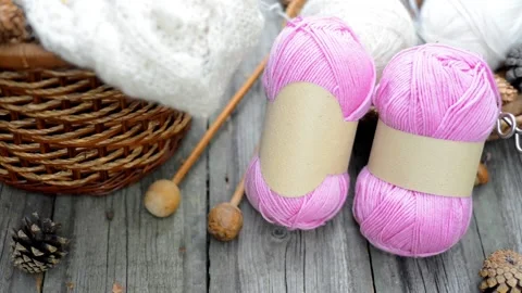 Closeup two pink balls of wool threads on vintage wood desk. Mock up background Stock Footage 118254611