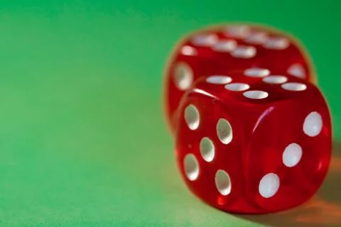 Closeup of a two red dice with a winning number on the top face on a green su Foto stock