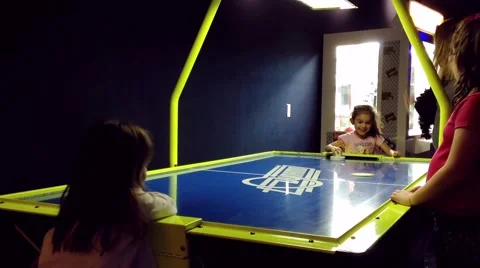 Closeup two young grils playing air hockey table game 스톡 동영상 48660895