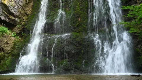 Closeup of a twofold waterfall in a forest 스톡 동영상 260851183