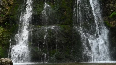 Closeup of a twofold waterfall in a forest (slow motion) Stock Footage 260851760