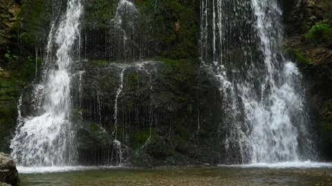 Closeup of a twofold waterfall in a forest (slow motion) 스톡 동영상 260851880