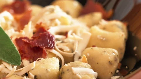 Closeup of typical italian gnocchi dumpling with dried tomato and cheese 스톡 동영상 233904156