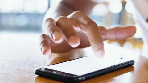 Closeup typing text message browsing scrolling smartphone of attractive Afr.. Stock Footage 272778595