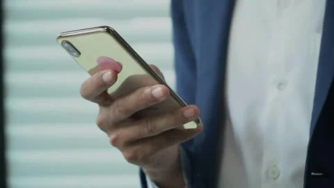 Closeup typing text message browsing scrolling smartphone of attractive African Stock Footage 336249360
