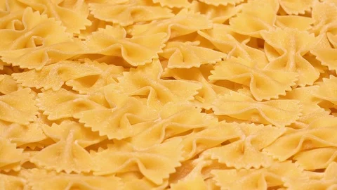 Closeup UHD 60 fps shot of the dry Farfalle pasta on a turntable Video stock 118344761