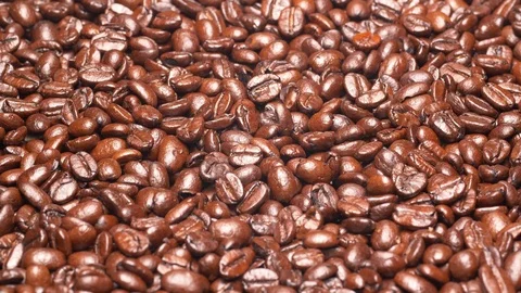 Closeup UHD 60 fps shot of the dark roasted coffee beans on a turntable Stock Footage 118345150