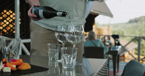 Closeup unknown waiter hand pouring wine into glass indoors Stock Footage 159180683