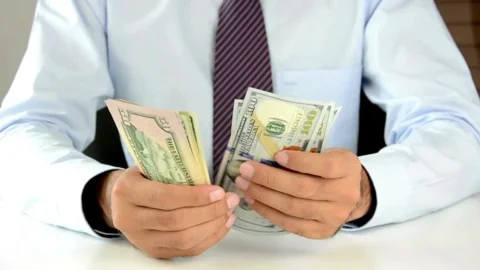 Closeup of unrecognizable Businessman hands counting expenses banknotes of Video stock 336261049