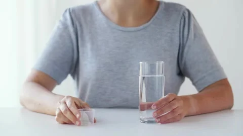 Closeup unrecognizable face shoot of person taking pill medicine health and Vídeos de archivo 336586430