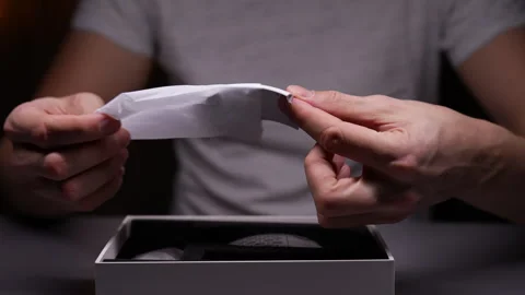 Closeup of unrecognizable man pulling out of box replacement backrest from new Stock Footage 264801208