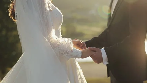 Closeup unrecognizable young man and woman holding hands. Unknown newlywed Video stock 196006844