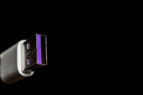 Closeup of USB cable. Isolated on black background Stock Photos