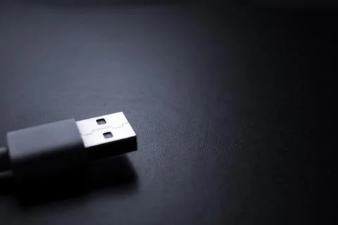 Closeup of USB cable. Isolated on black background Stock Photos
