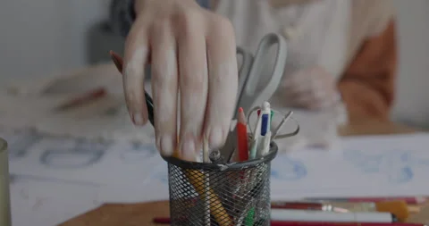 Closeup of various art tools and brushes in a holder on a creative workspace Stock Footage 301616844