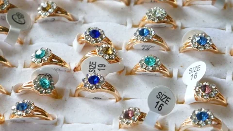 Closeup of various silver rings with diamonds on showcase in jewelry store Stock Footage 81157887
