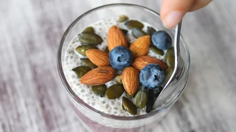 Closeup Of Vegan Chia Pudding With Nuts And Berries. Healthy Diet Concept. 動画素材 86581419
