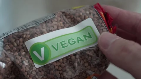 Closeup on the Vegan Label Certification on a Package of Buckwheat Vídeos de archivo 250121553