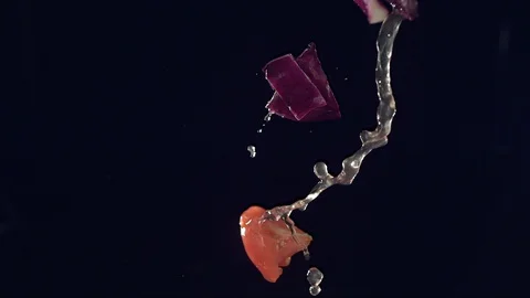 Closeup of vegetables fruit and ice falling across screen in slow motion A Stock Footage 109572813