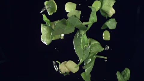 Closeup of vegetables fruit and ice falling across screen in slow motion E Stock Footage 109573183