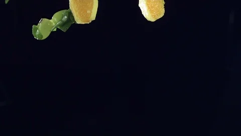Closeup of vegetables fruit and ice falling across screen in slow motion D Stock Footage 109573248