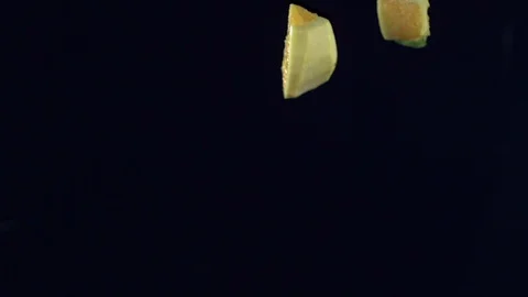 Closeup of vegetables fruit and ice falling across screen in slow motion G Stock Footage 109573553