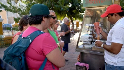 Closeup of vendor preparing and serving churros in the park in Valladolid Stock Footage 128830805