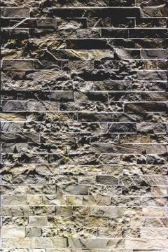 Closeup vertical shot of a tiled irregular rough wall texture background Stock Photos