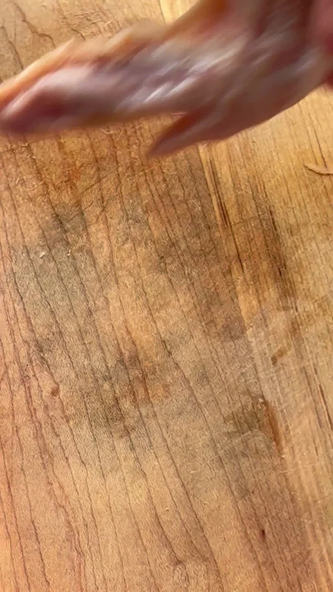 Closeup vertical view of man disjointing chicken wings Stock Footage 242374098