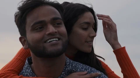 Closeup of very attractive middle eastern couple smiling on beach Stock Footage 111977070