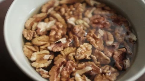 Closeup video of activated hydrated walnuts in a bowl. Stock Footage 322171797