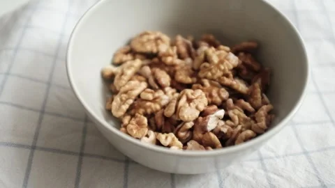 Closeup video of activated hydrated walnuts in a bowl. Stock Footage 322171817