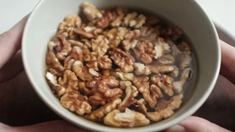 Closeup video of activated hydrated walnuts in a bowl. Stock Footage 322171828