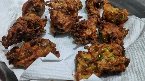 Closeup video of deep fried onion pakora or crispy fritters being dried on .. Video stock 314031245