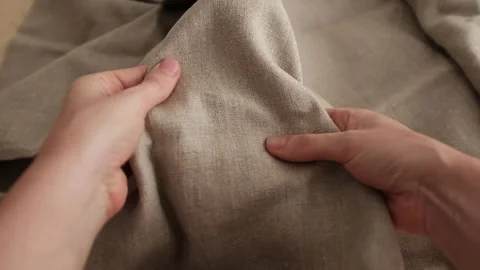 Closeup video of hands touching rough linen fabric. Stock Footage 317094222
