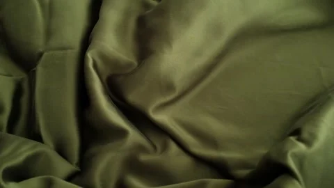 Closeup video of hands touching soft green silk fabric Stock Footage 317094090